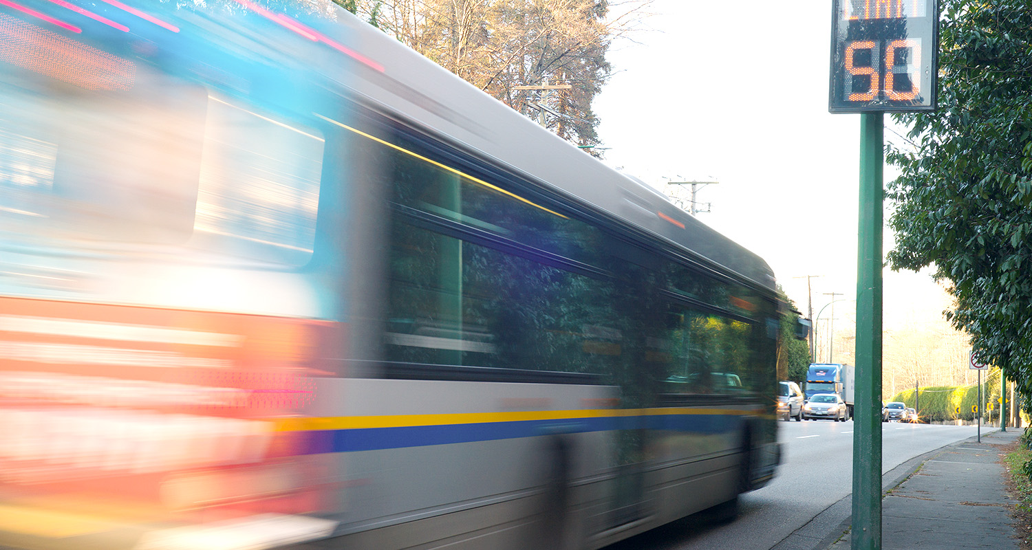 city-bus-driving-down-large-thoroughfare-motion-blur-image